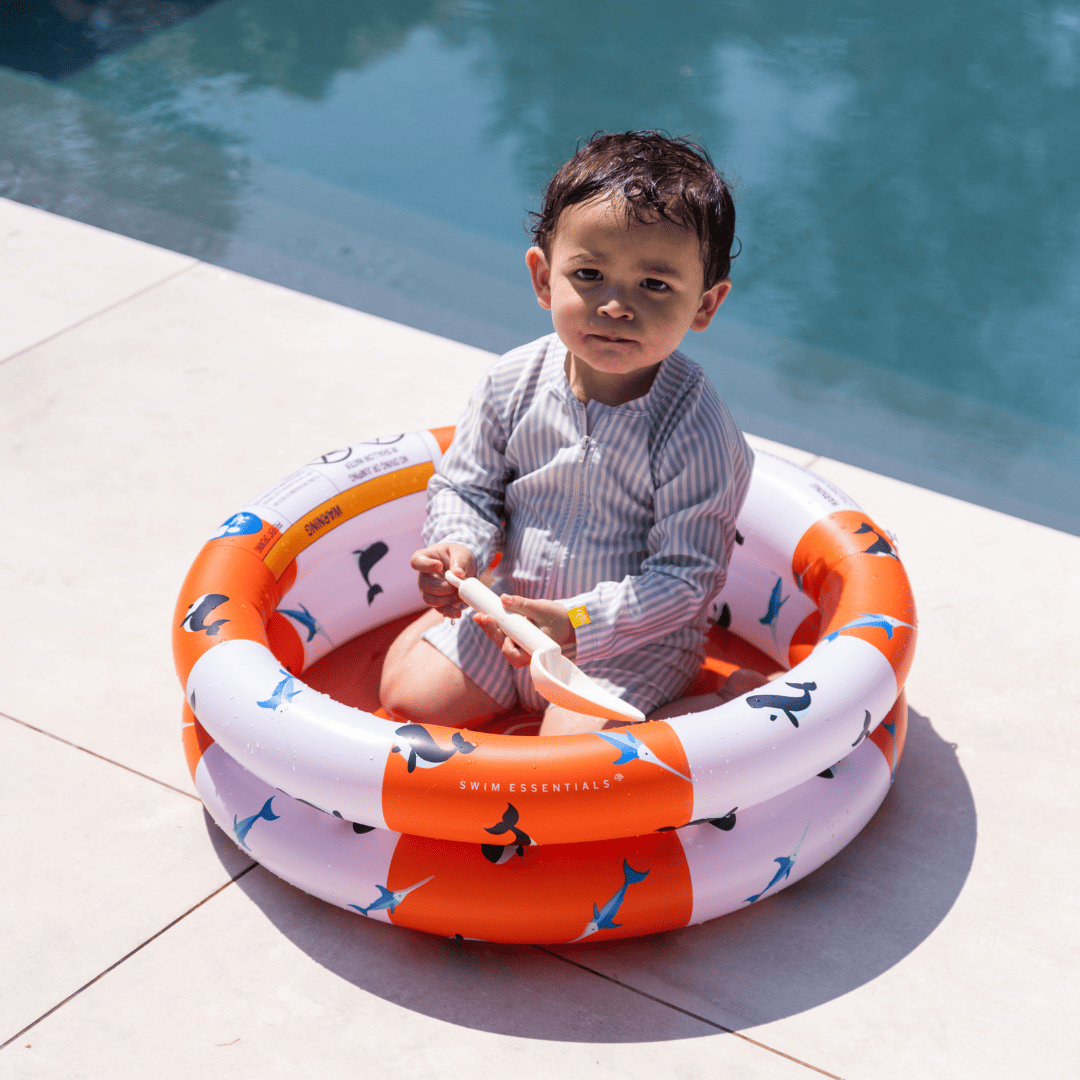 child playing in baby pool